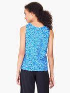 Blue sleeveless tank top with white and dark blue leopard print.  Back view.