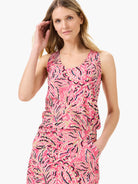Pink sleeveless tank top with a floral pattern in beige, pink, and black.
