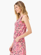 Pink sleeveless tank top with a floral pattern in black, beige, and white.  Seams are visible.