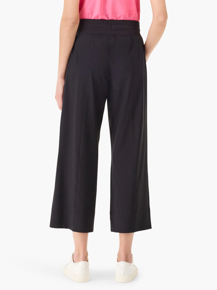 Black wide-leg cropped pants;  elastic waistband; model wears white shoes.