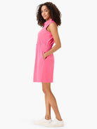 Pink sleeveless collared dress, cinched waist, pockets.