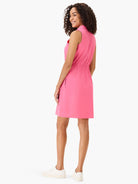 Pink sleeveless collared dress with drawstring waist.  Back view.