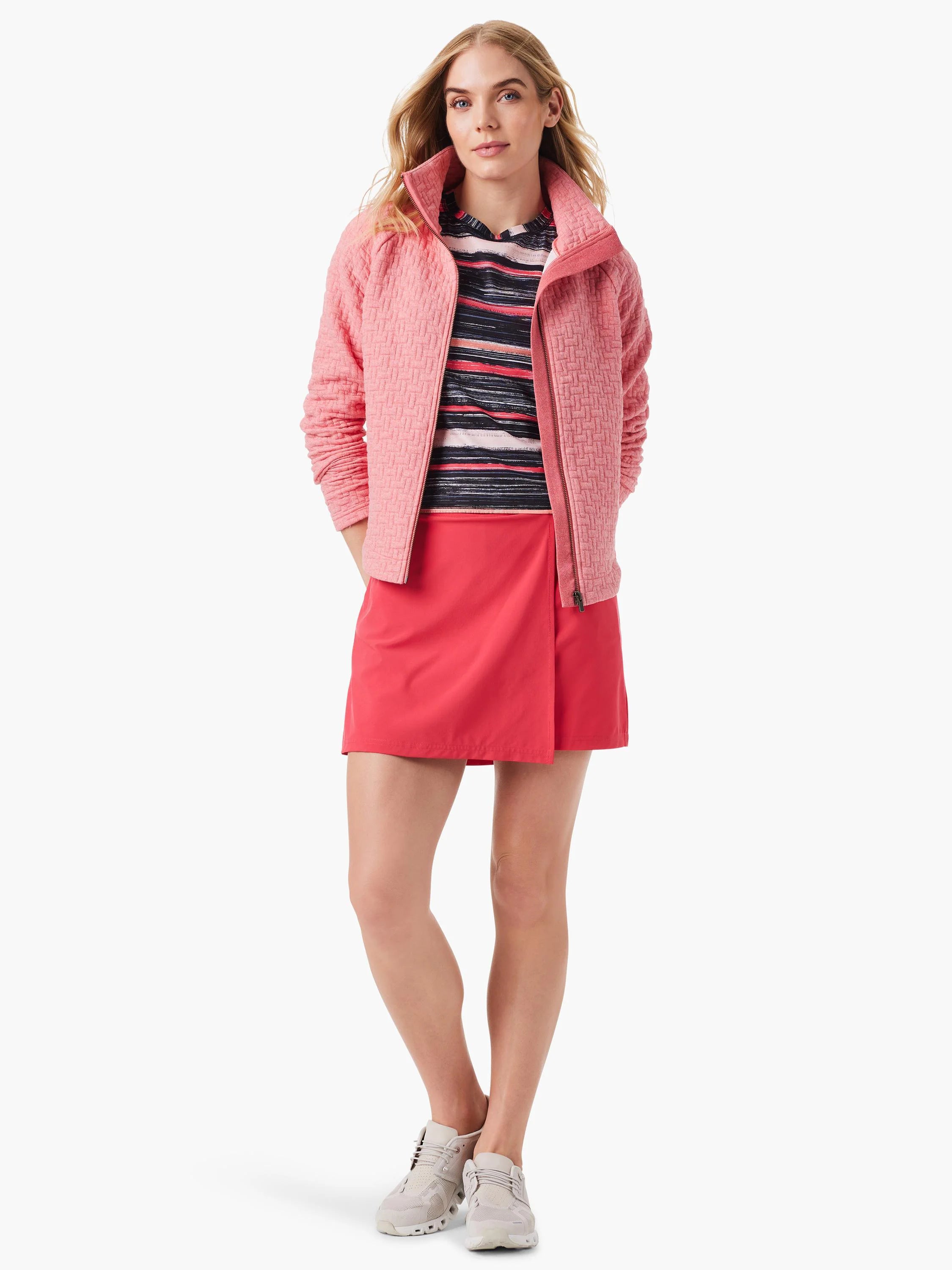 Pink quilted jacket with a zipper, shown on a model.  The jacket has a textured weave pattern.