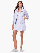 Light lavender quilted jacket, zipper front.  Model also wears a light lavender skirt and neutral-toned sneakers.
