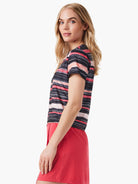Short-sleeved shirt; black, red, and peach horizontal stripes in a painted style.