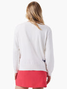 White dotted sweater with navy blue and dark gray small dots.  Long sleeves, ribbed bottom hem.