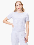 Lavender short-sleeve sweater tee with a light-colored textured pattern.