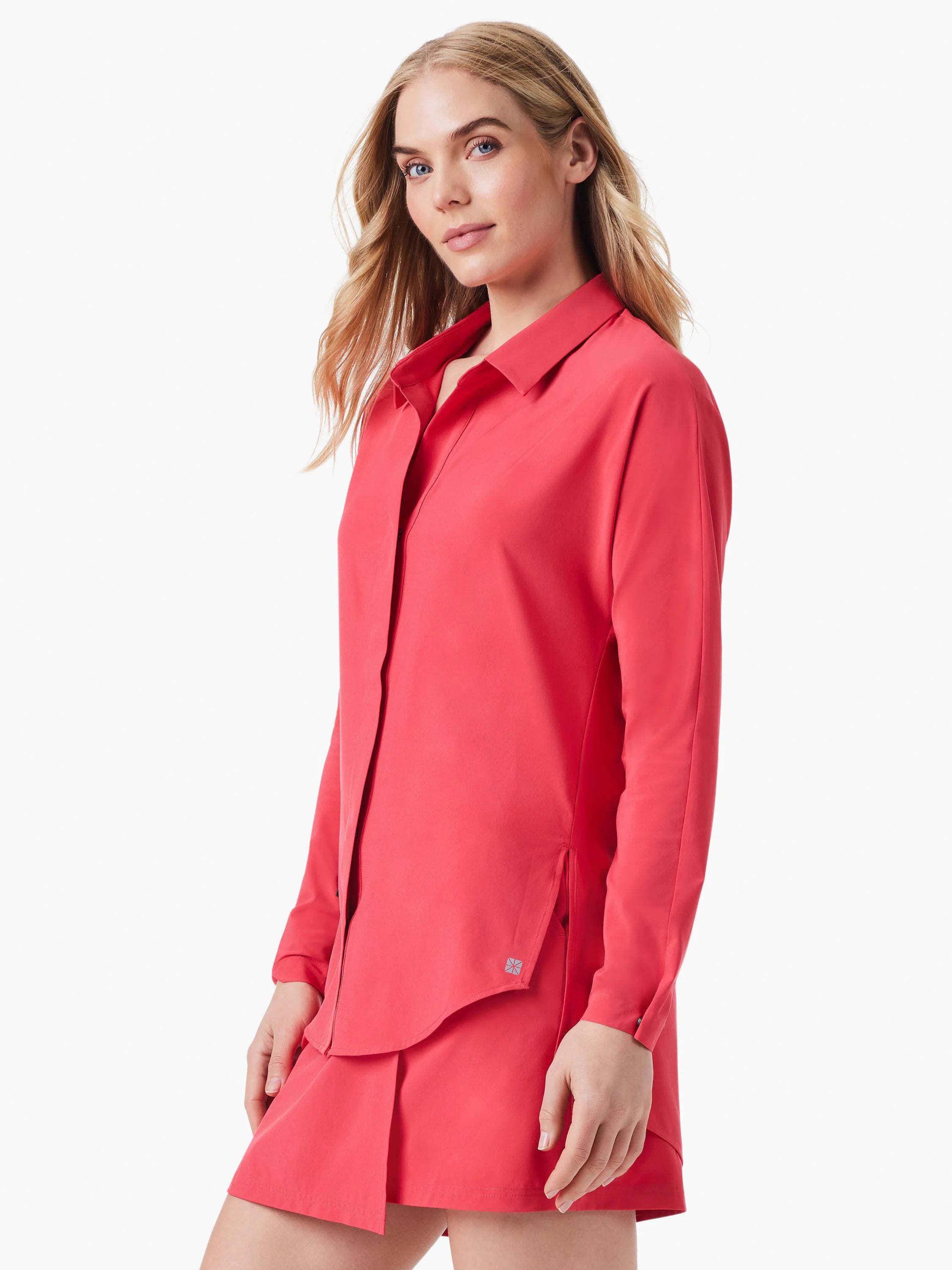 Coral long-sleeve collared shirt with an open neckline, side slits at the hem, and a small logo detail.