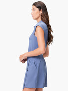 Dusty blue short jumpsuit; snap neck, short sleeves, and pockets.
