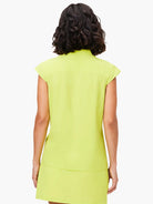 Lime green sleeveless snap-neck top, shown from the back.