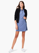 Dusty blue skort, worn with a black zip-up jacket and white sneakers.  The skort has a faux wrap design.