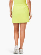 Here's alt text for the image, under 125 characters:

Bright yellow skort, rear view.  Elastic waistband.  Model wearing...