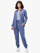 Slate blue joggers with drawstring waist, ruched leg details, and tapered cuffed ankles.