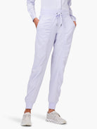 Lavender joggers with drawstring waist, side pockets, vertical front seams, and ruched ankle cuffs.