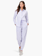Pale lavender tech stretch joggers with a drawstring waist, visible front seams, and ruched ankle cuffs.