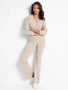 Beige wrap top and flared pants.  Long sleeves.  Model is wearing off-white sneakers.