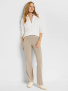 White textured polo shirt with subtle stripes; long sleeves, collared.