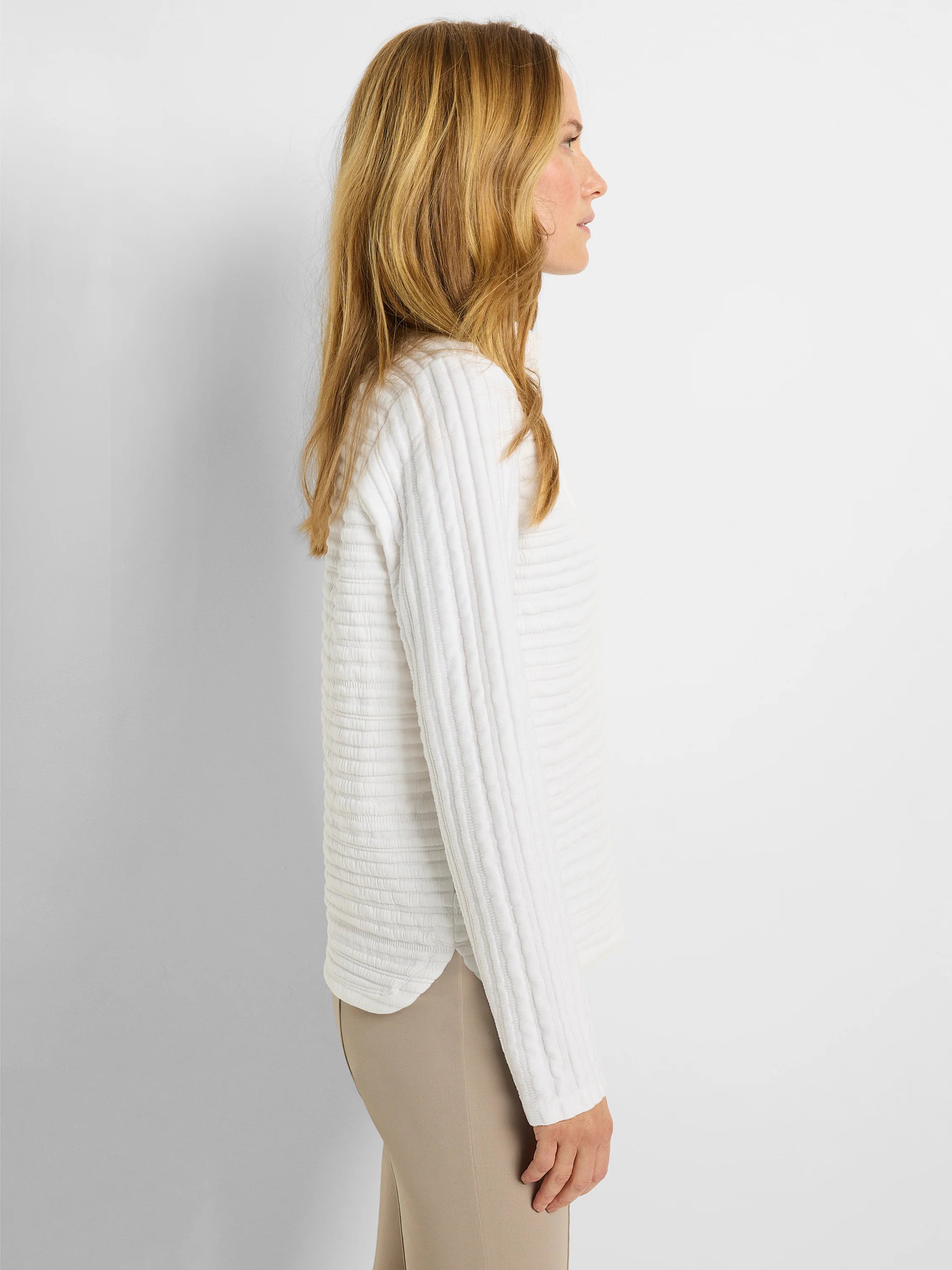 White long-sleeve polo shirt with textured vertical stripes.  Off-white background.