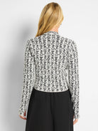 Off-white cardigan with black "BALANCE" lettering.  Long sleeves, mock neck.