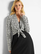 Off-white cardigan with black "Balance" text repeat print;  long sleeves, open front tied at waist.