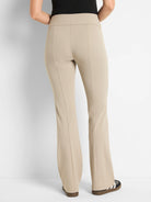 Beige bootcut pants; high-waisted, with center seams.
