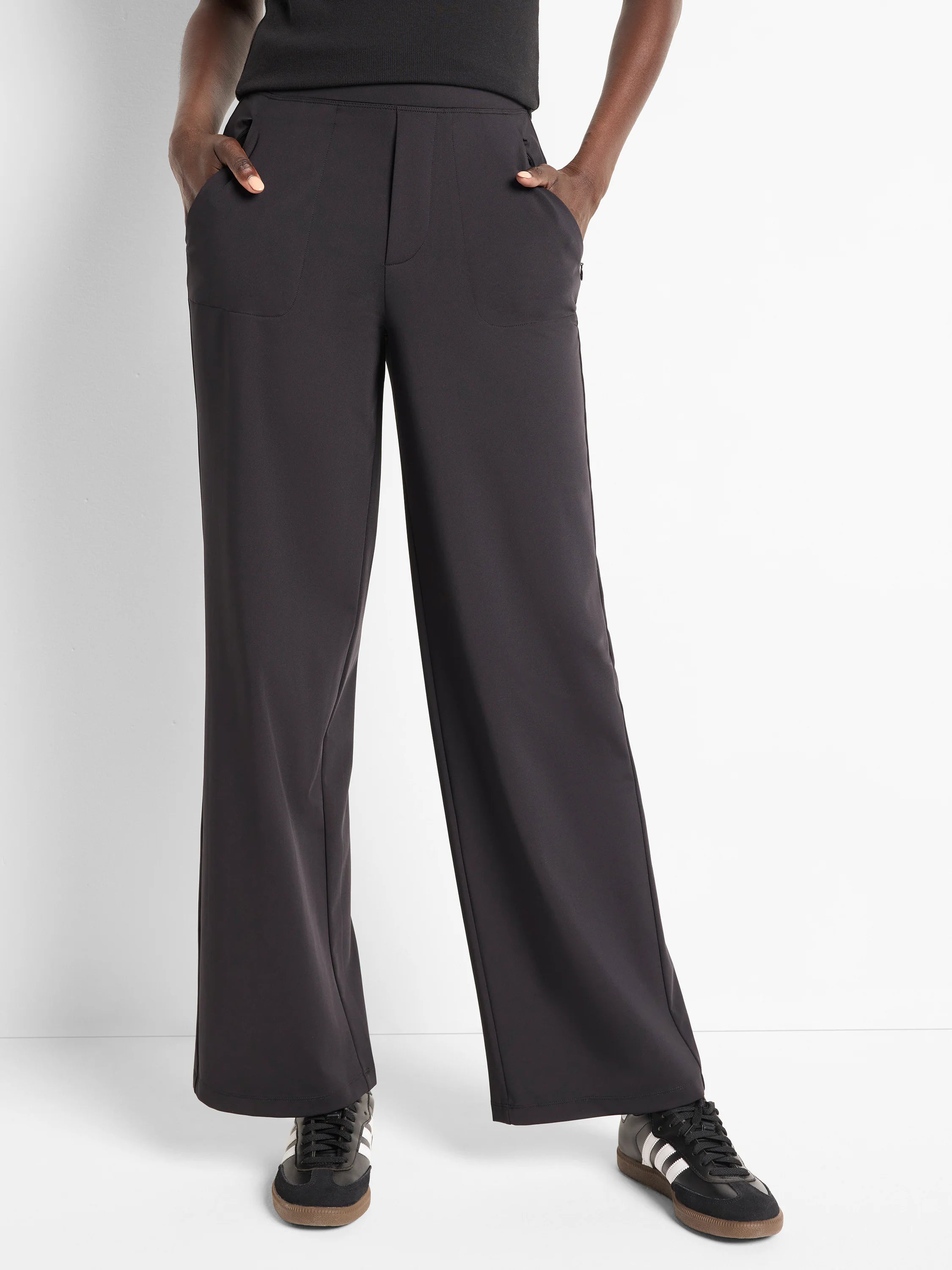 Dark gray wide-leg pants;  high waist, pockets, and a straight hem.