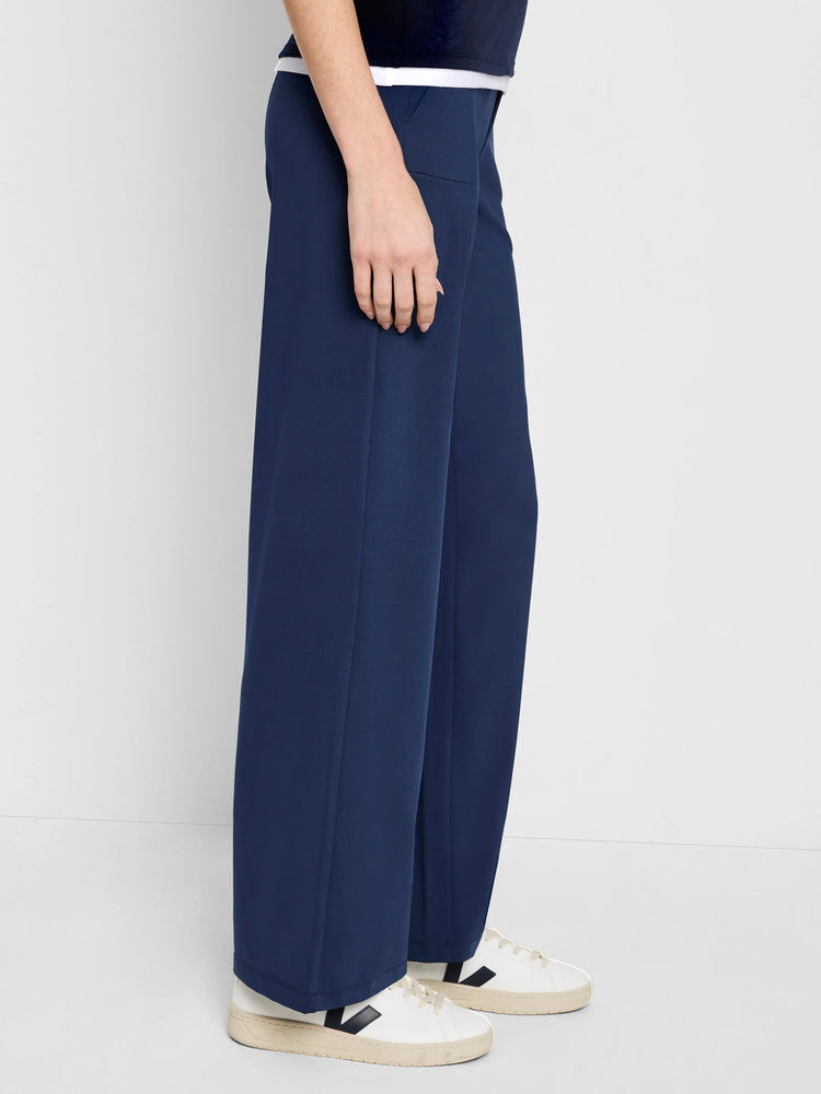 Here's alt text for the image, under 125 characters:

"Image shows dark blue wide-leg pants. The pants are shown from the...