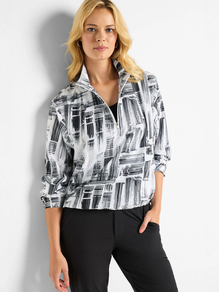 White popover with black abstract brushstroke pattern, half-zip closure.