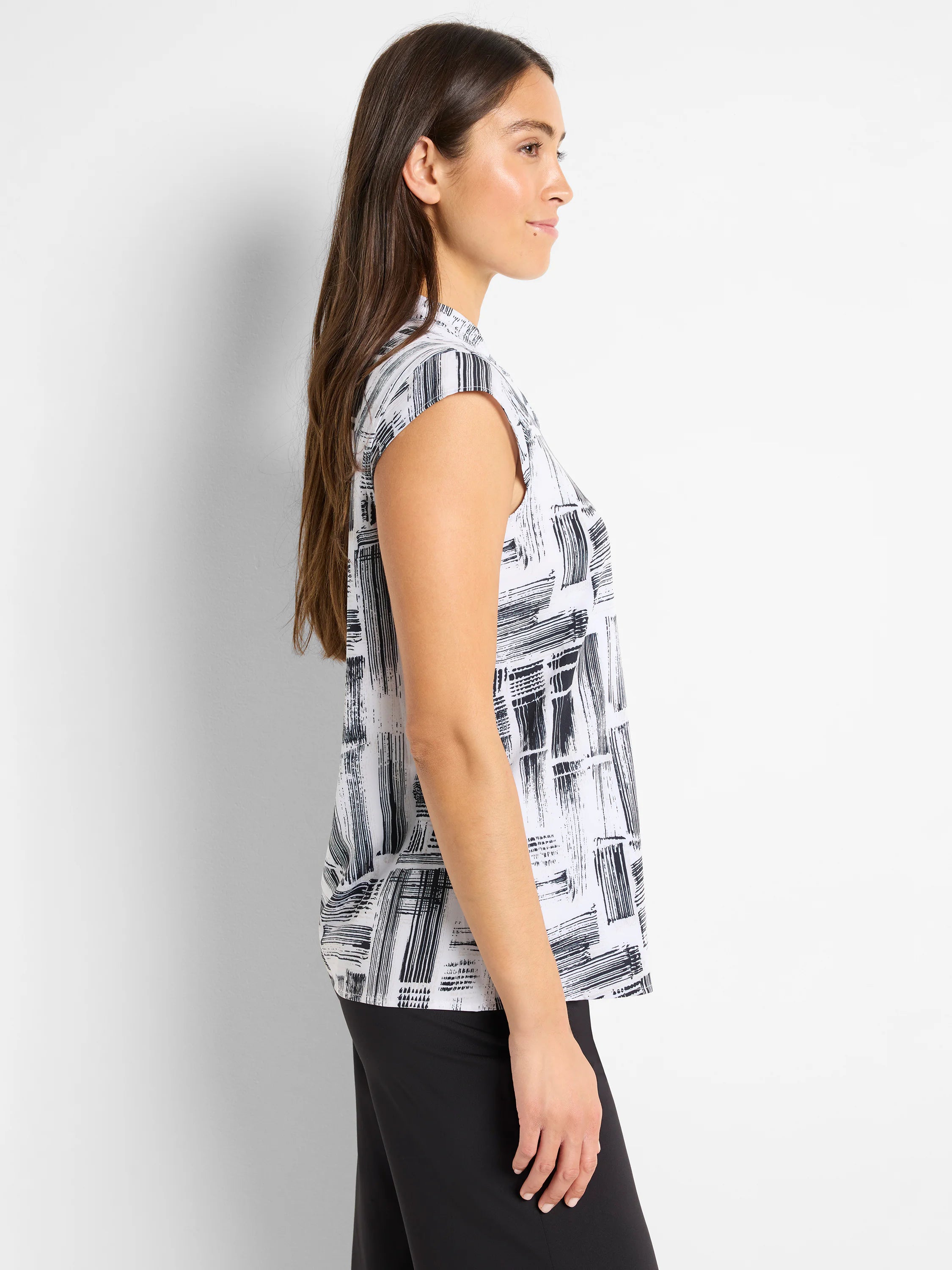 White tank top with black brushstroke pattern, snap neck, short sleeves.