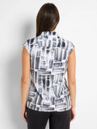 White sleeveless snap-neck top with black brushstroke pattern.
