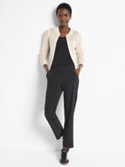Black straight-leg pants; model wears off-white cardigan.