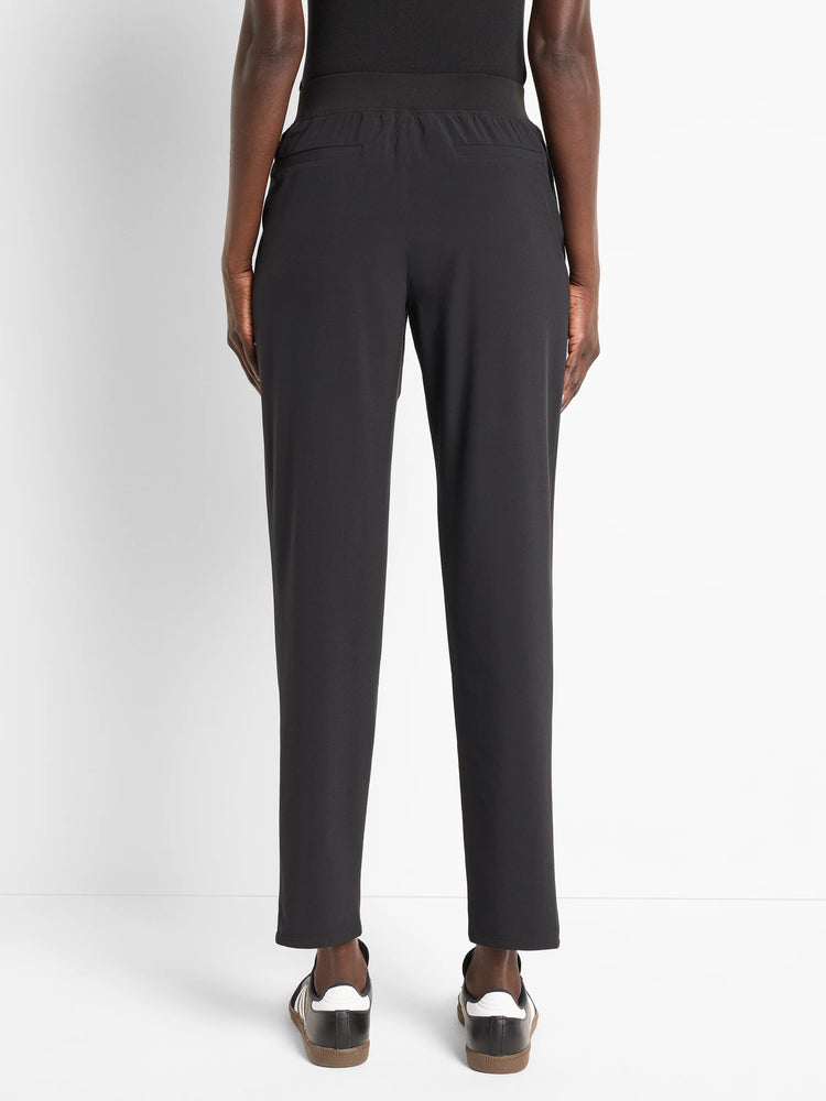 Black ankle-length pants with elastic waistband and back pockets.  Model is wearing black shoes.