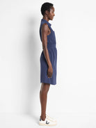 Navy blue sleeveless shirt dress, cinched waist, above-knee length.