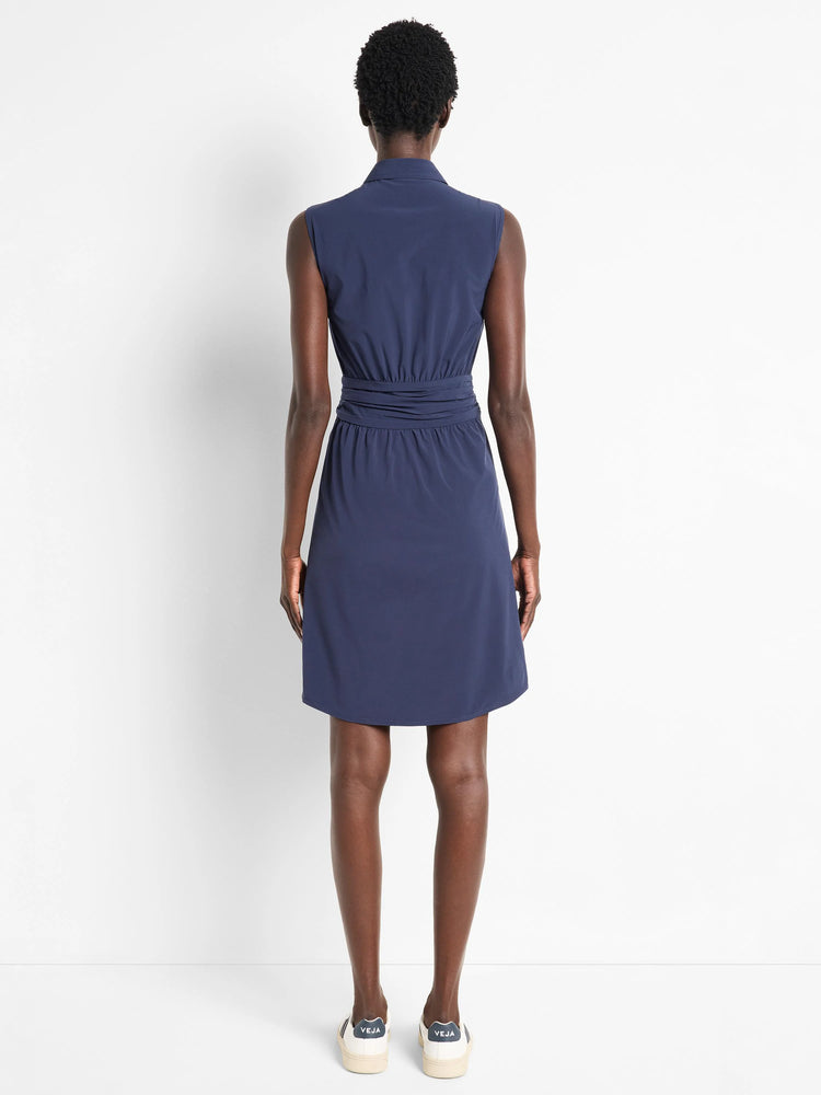 Navy blue, sleeveless, collared dress; cinched waist; above-knee length.