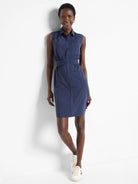 Navy blue sleeveless shirt dress with buttons, pockets, and a cinched waist.  Knee-length.
