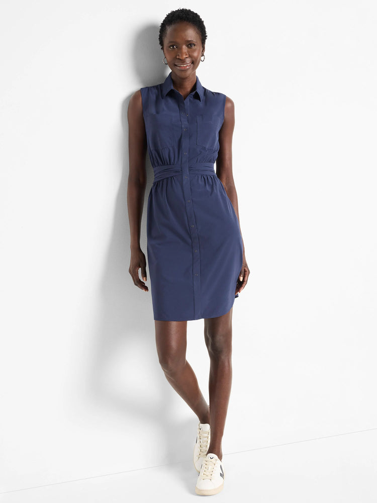 Navy blue sleeveless shirt dress with buttons, pockets, and a cinched waist.  Knee-length.
