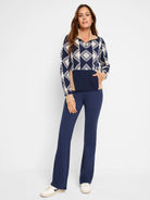 Navy blue half-zip sweater with beige and white diamond pattern, and a solid navy blue bottom section and pocket.