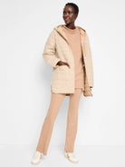 Beige hooded quilted coat, reversible.  One side is textured, the other is quilted.  Features pockets.