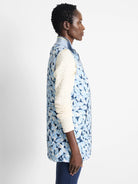 Reversible vest; light blue with dark blue floral pattern on one side.  The other side is not shown. Quilted.  Zipper front.