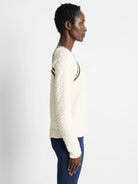 Off-white textured pullover sweater with yellow and navy blue stripes across the shoulders.