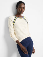 Off-white textured sweater with yellow and navy blue stripes at neckline and raglan sleeves.