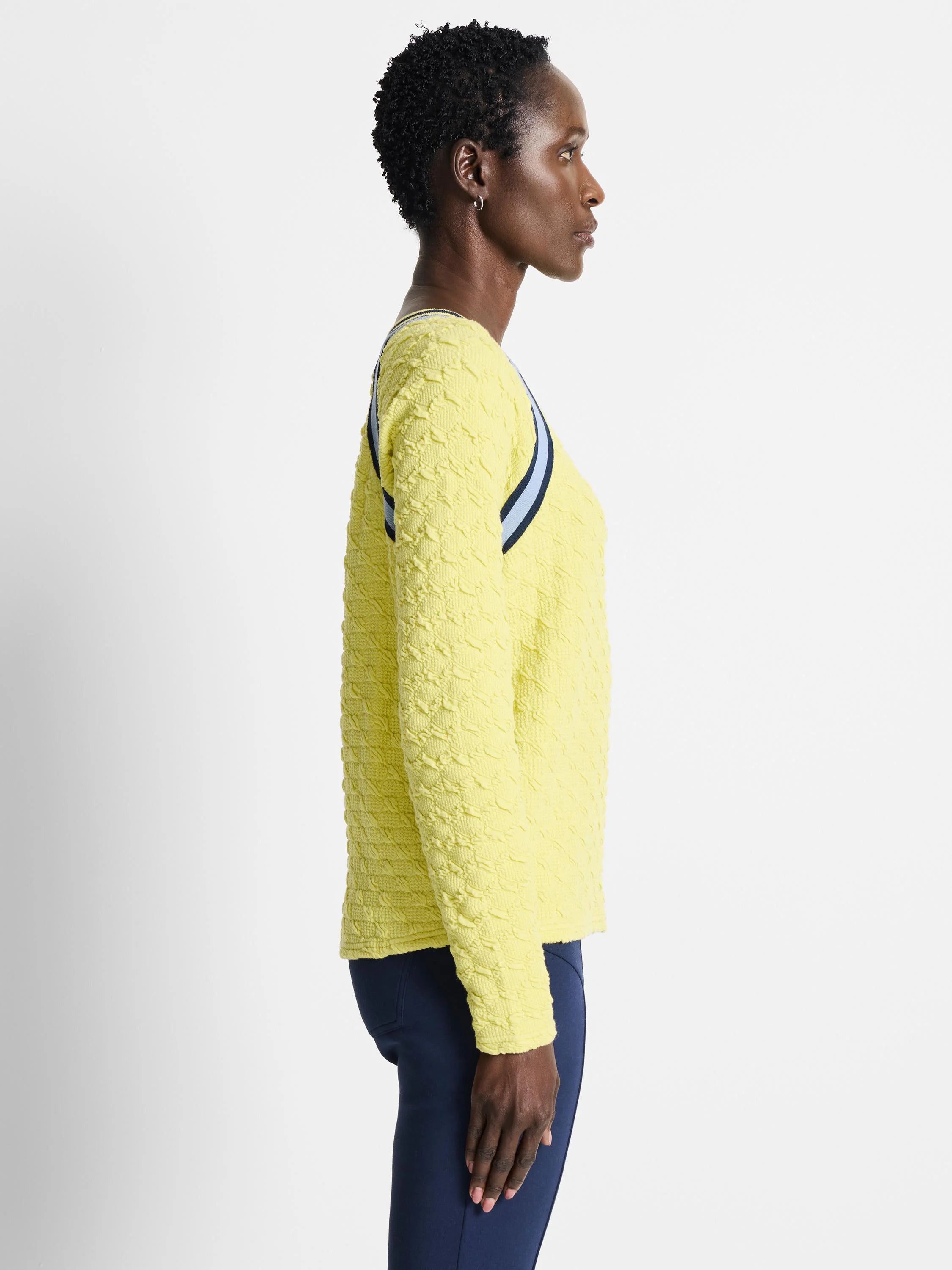 Pale yellow textured pullover sweater with navy and light blue shoulder stripes.  Long sleeves.