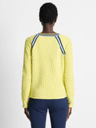 Pale yellow textured pullover sweater with navy and light blue shoulder stripes.  Long sleeves.