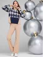 Beige bootcut pants.  Seams visible. Model is wearing them with a navy and cream patterned sweater.