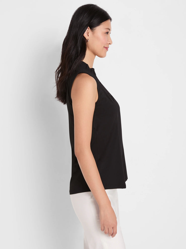 Black sleeveless tank with a ruffled stand collar, shown on a model in profile.