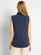 Navy sleeveless tank with ruffled stand-up collar and curved hem. Shown from the back.