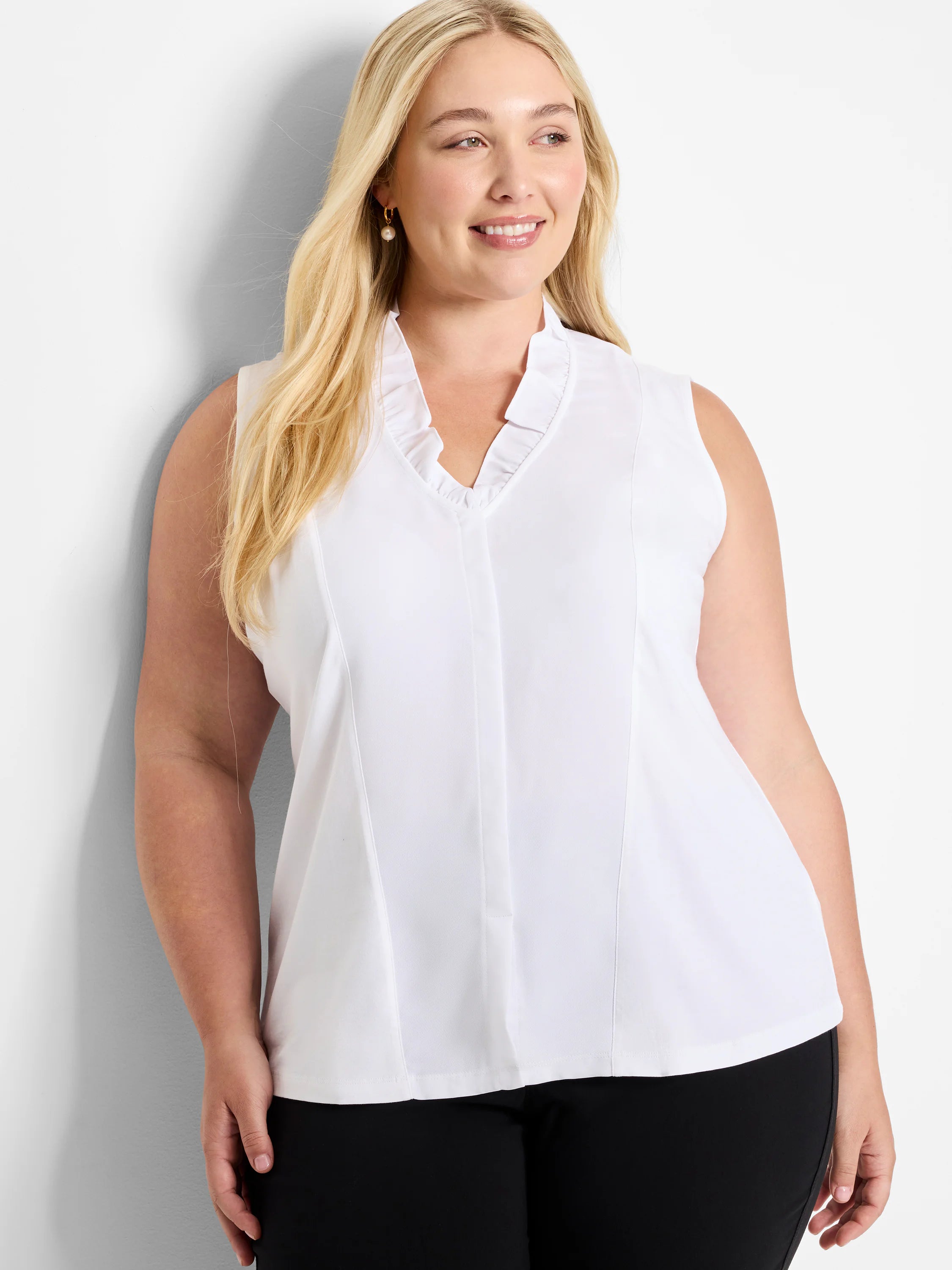 White sleeveless tank with ruffled V-neck.