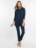 Navy blue long-sleeved crew neck tee, worn under an open matching cardigan; full outfit is navy blue.