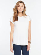 White Eaze Tee on model. Short sleeve, crew neck, relaxed fit, straight hem.