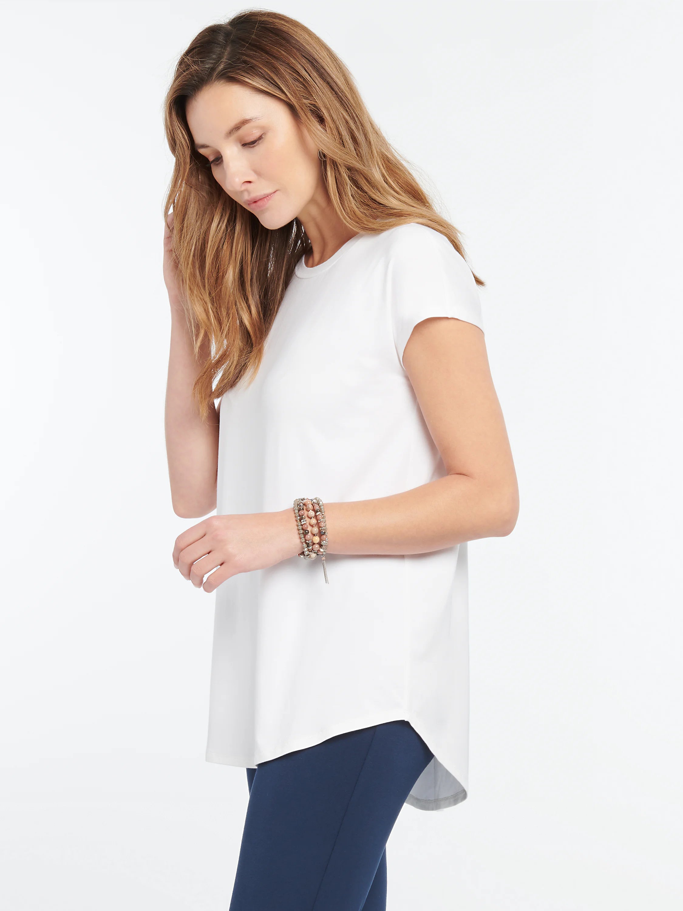 White Eaze Tee: round neck, short sleeves, relaxed fit, with a curved high-low hem.